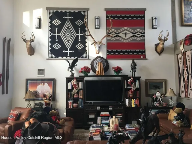 a room with lots of books and a mirror