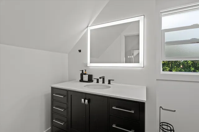 a bathroom with a sink and a mirror