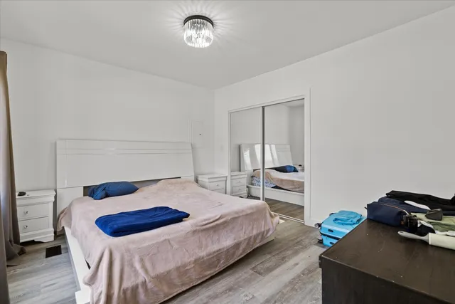 a bedroom with a bed and a chandelier