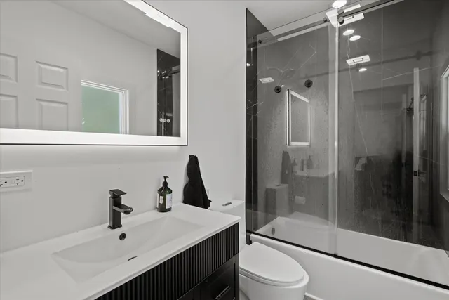a bathroom with a sink toilet and shower