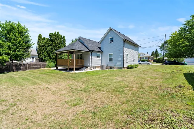 a front view of a house with yard and green space