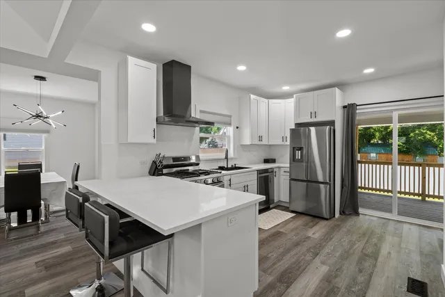 a kitchen with refrigerator cabinets and wooden floor