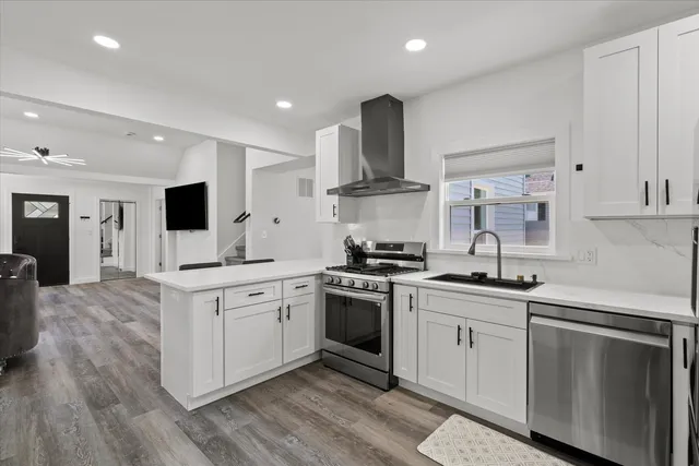 a kitchen with stainless steel appliances granite countertop a sink and stove top oven
