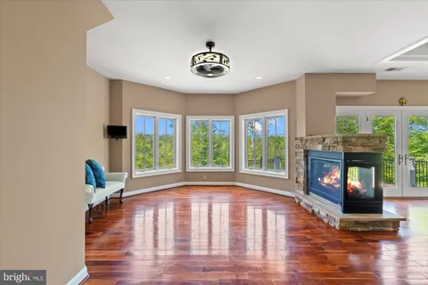 a bathroom with a granite countertop sink a large mirror and a shower
