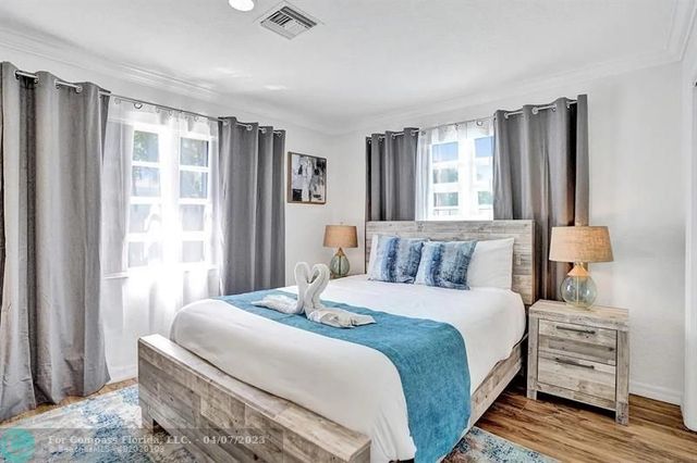 a living room with kitchen island furniture and a wooden floor