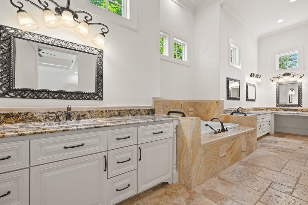 102 Long Point Cove Georgetown, TX 78628 - Photo 20 of 36 a bathroom with a granite countertop double vanity sink a mirror and bathtub