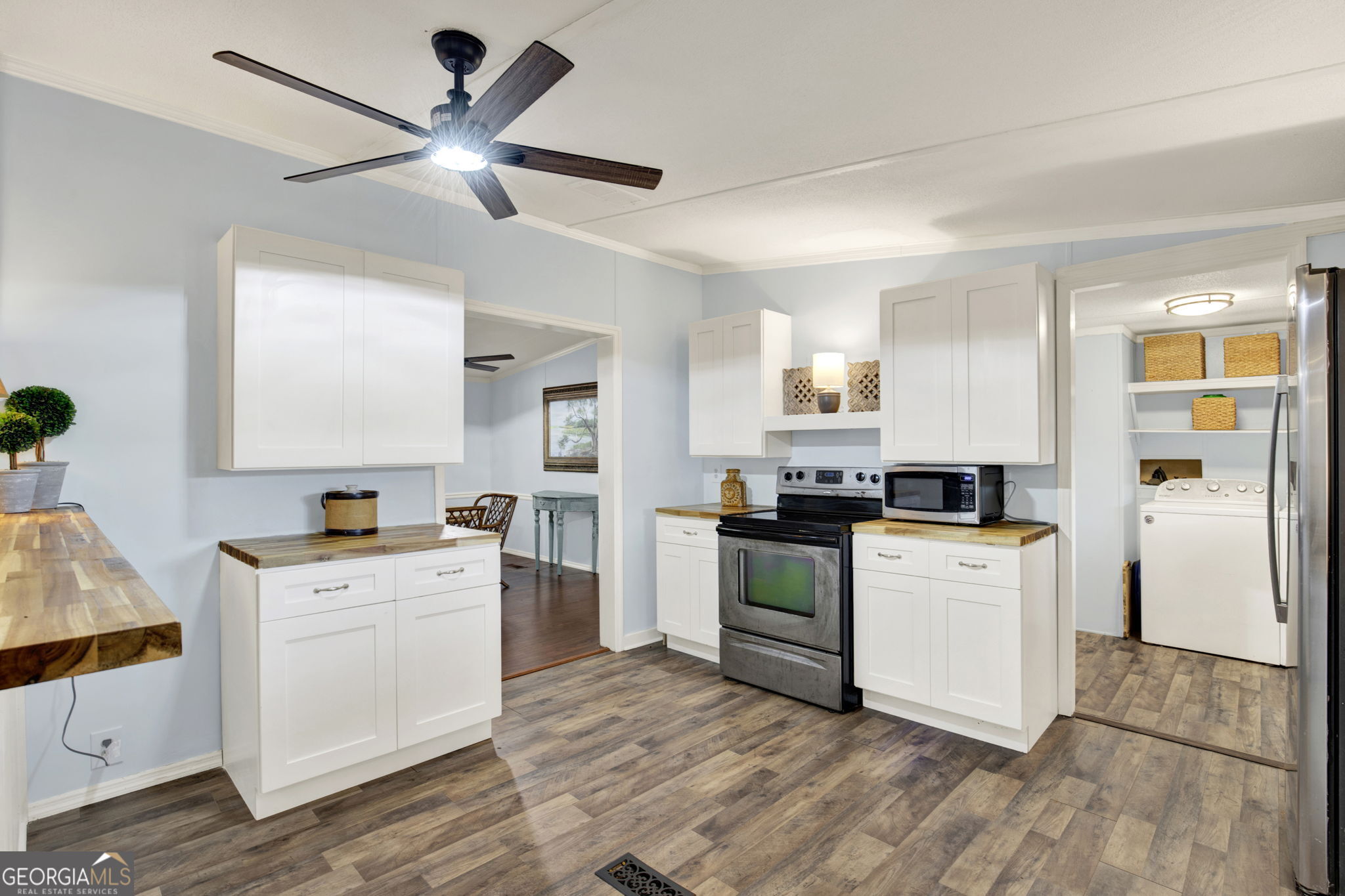 1262 Doodle Hill Road Northeast Townsend, GA 31331 - Photo 15 of 44 a kitchen with white cabinets and white appliances