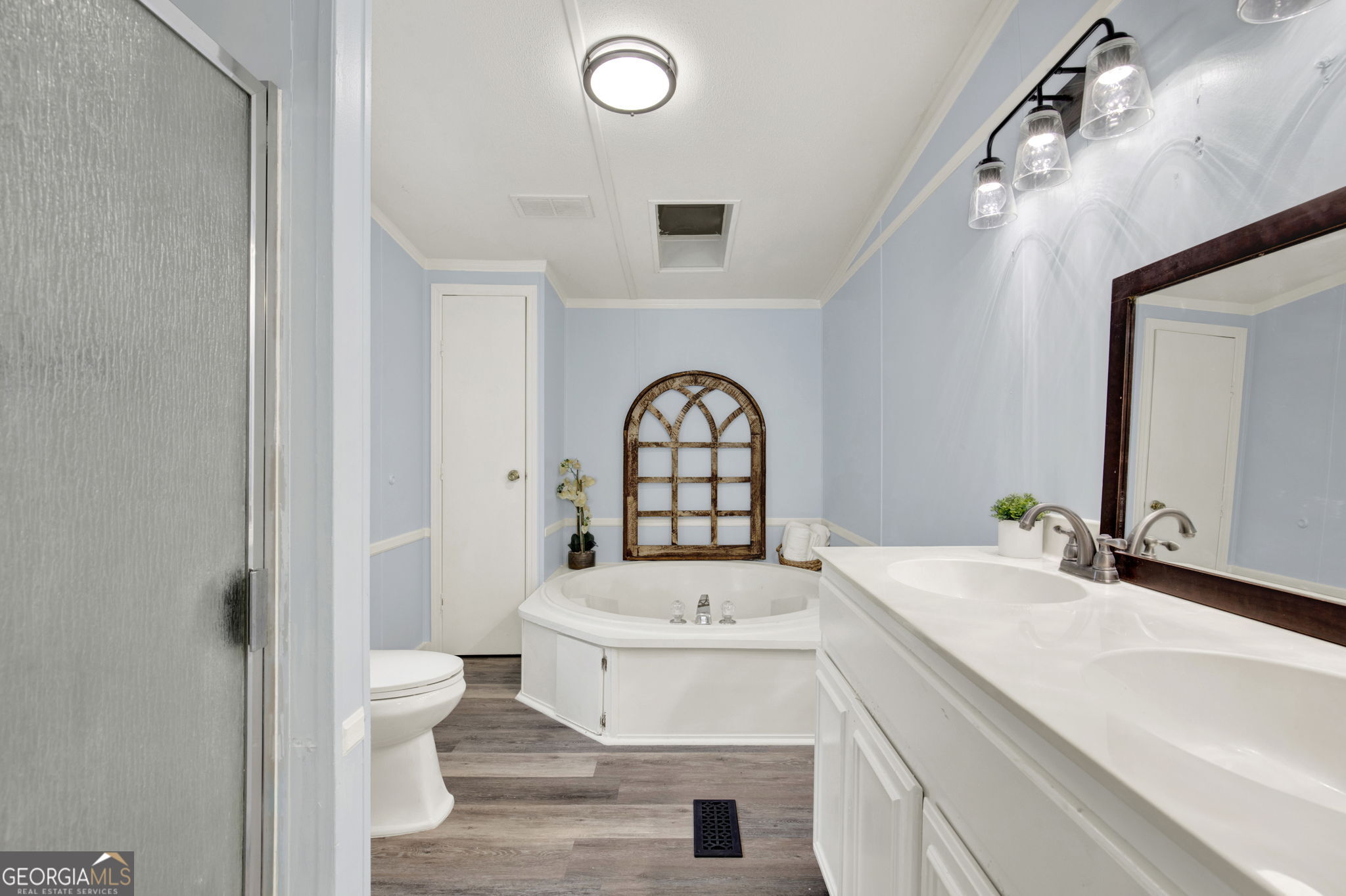 1262 Doodle Hill Road Northeast Townsend, GA 31331 - Photo 28 of 44 a bathroom with a sink a toilet and a mirror