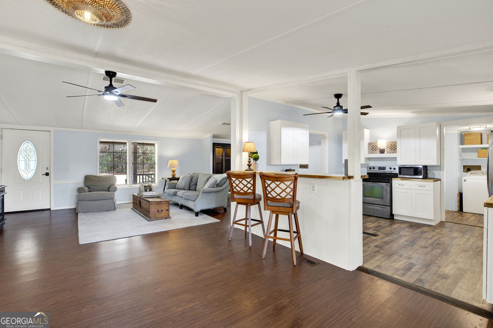 1262 Doodle Hill Road Northeast Townsend, GA 31331 - Photo 10 of 44 a living room with couches and kitchen view with wooden floor