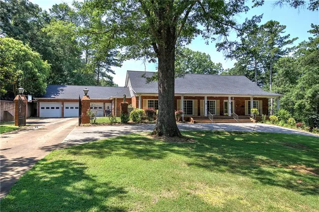 a front view of a house with a garden