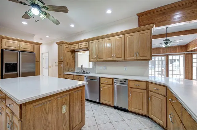a kitchen with stainless steel appliances granite countertop a sink and dishwasher with a stove top oven
