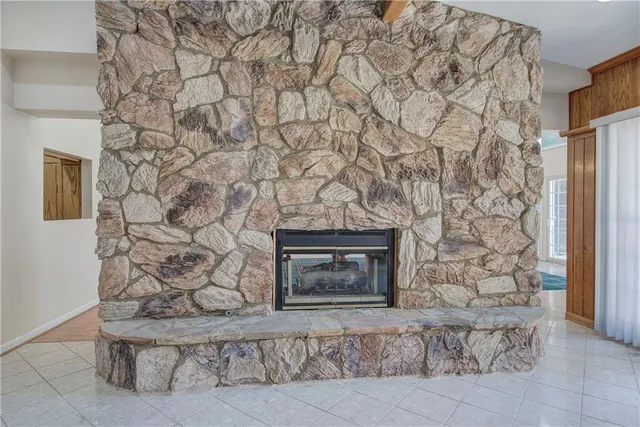 a room with a bench and a fireplace