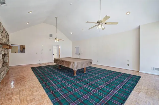 a living room with a rug and wooden floor