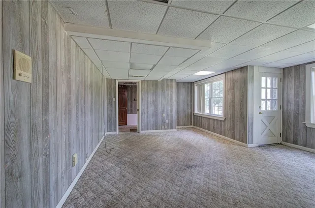 an empty room with closet and windows