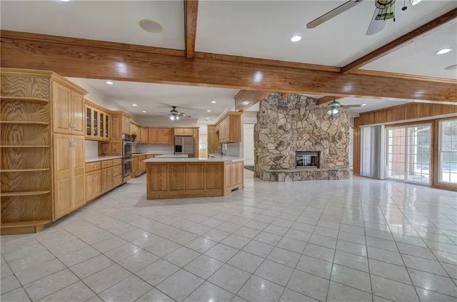 a large white kitchen with a sink and cabinets
