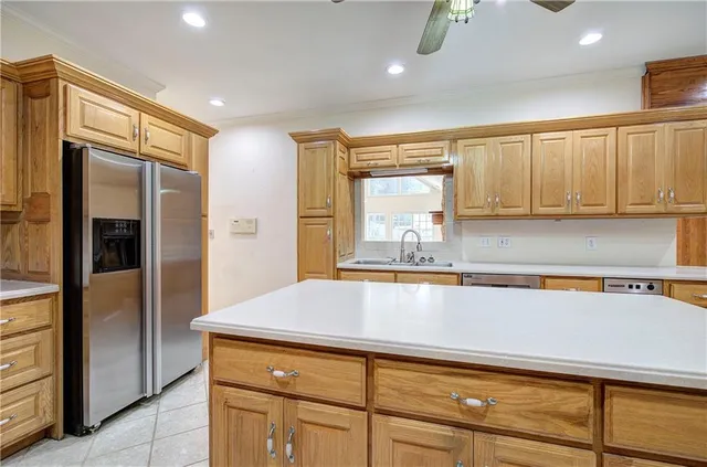 a kitchen with stainless steel appliances a refrigerator and cabinets