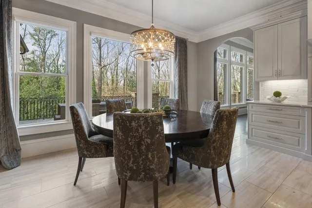 a living room with furniture a rug and a chandelier
