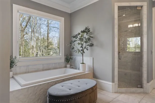 a living room with furniture a flat screen tv and large windows