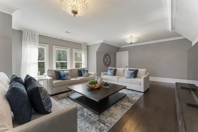 a living room with fireplace furniture and a large window