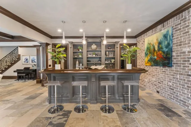 a living room with furniture a fireplace and a floor to ceiling window