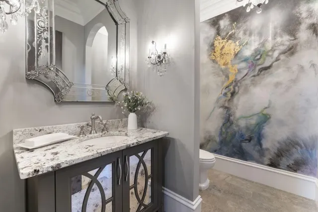 a kitchen with stainless steel appliances granite countertop a sink a stove top oven a counter space and cabinets