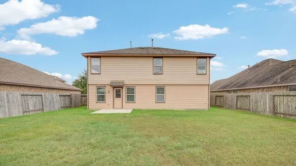 a front view of house with yard and garage