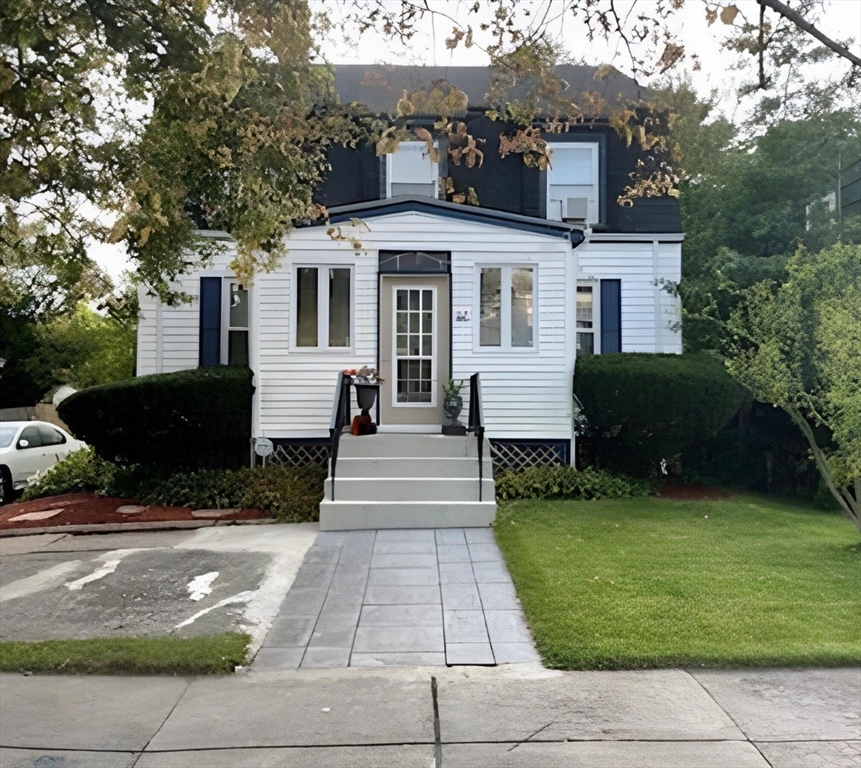 a front view of a house with a garden