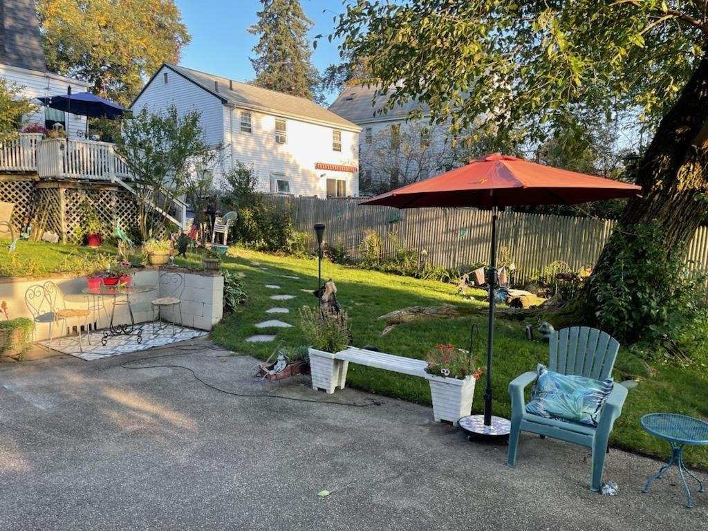 60 Bradlee Street Boston, MA 02136 - Photo 6 of 12 a view of a wooden table and chairs under an umbrella in backyard