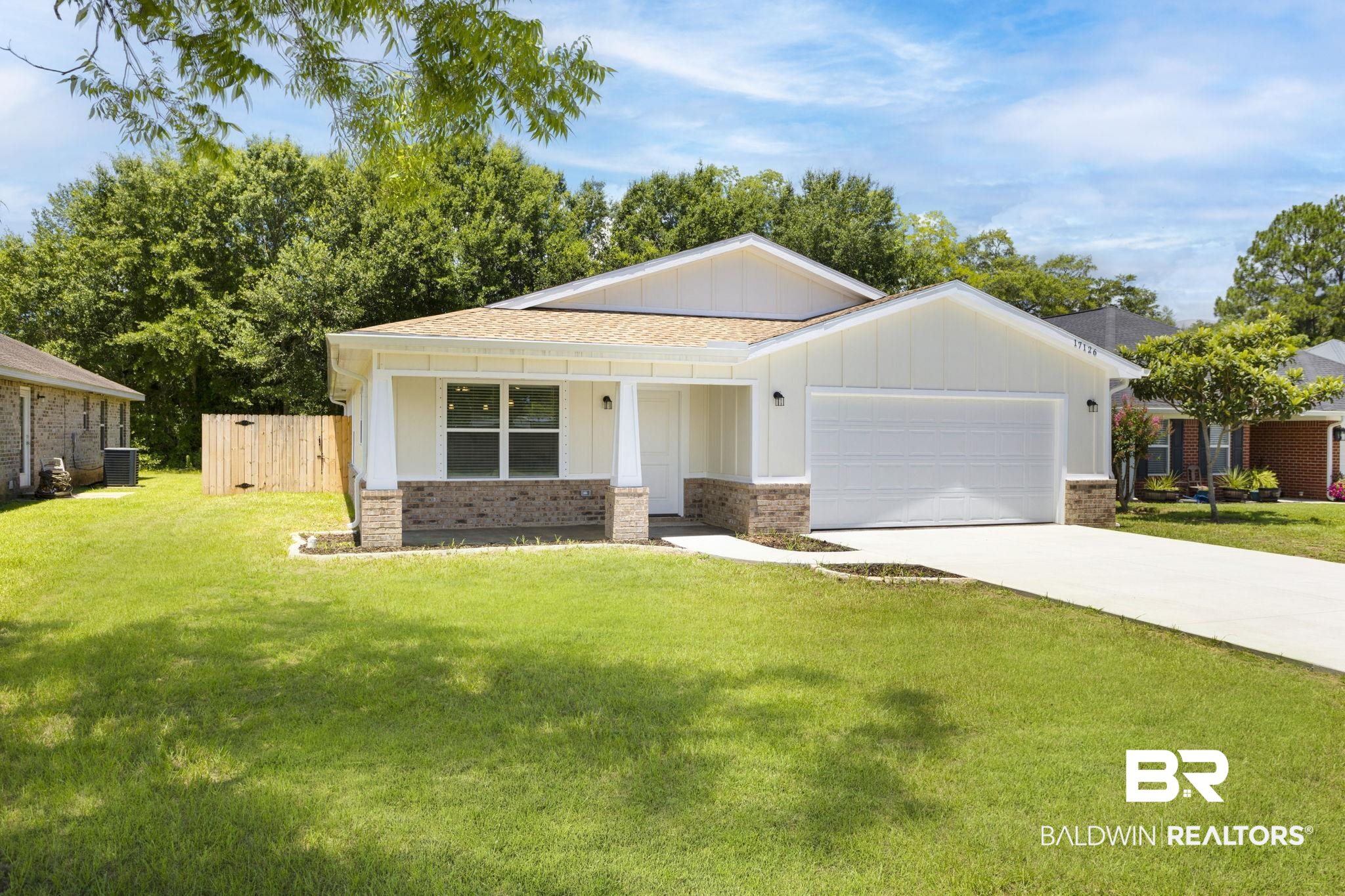 17126 Sugar Loop Foley, AL 36535 - Photo 1 of 28 View of front of property featuring board and batten siding, an attached garage, brick siding, driveway, and roof with shingles