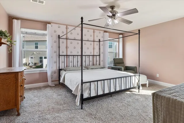 a bed sitting in a bedroom next to a window