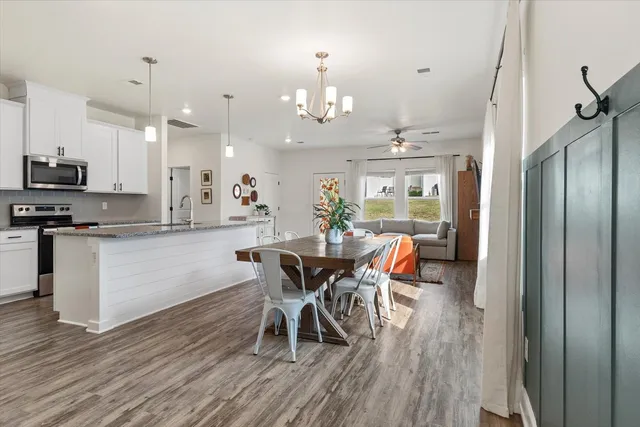a view of a dining room with furniture and wooden floor