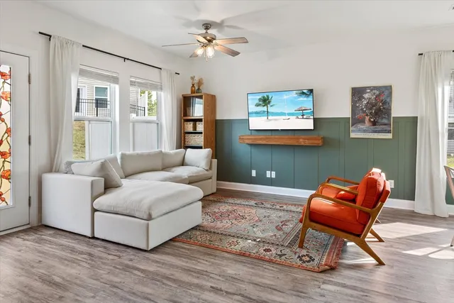 a living room with furniture a rug and a window