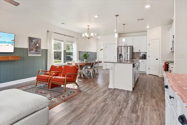 a living room with furniture and a wooden floor