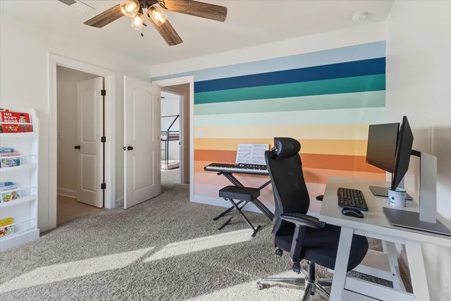 a view of a workspace with furniture and a window