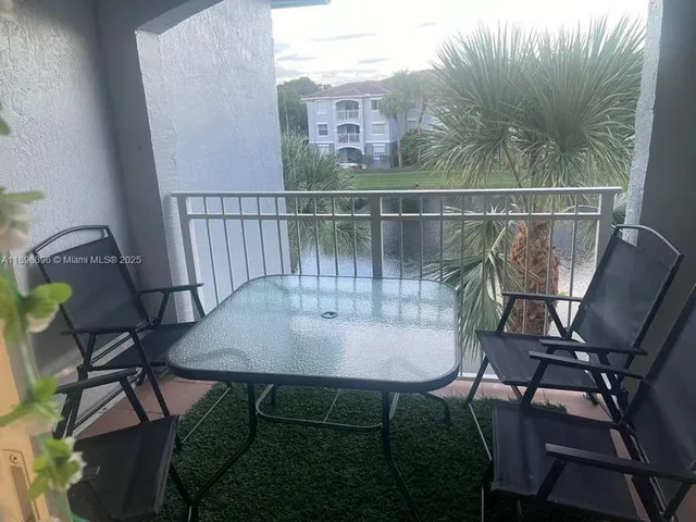 a view of a chairs and table in patio