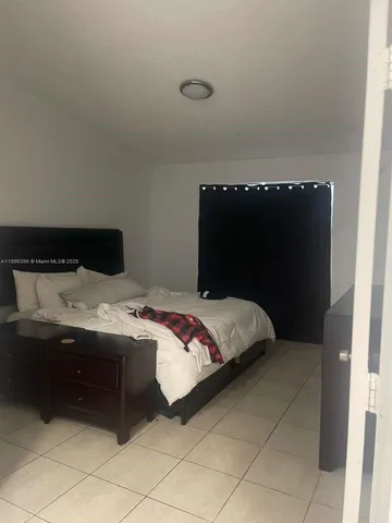 a bedroom with a bed and a cabinets