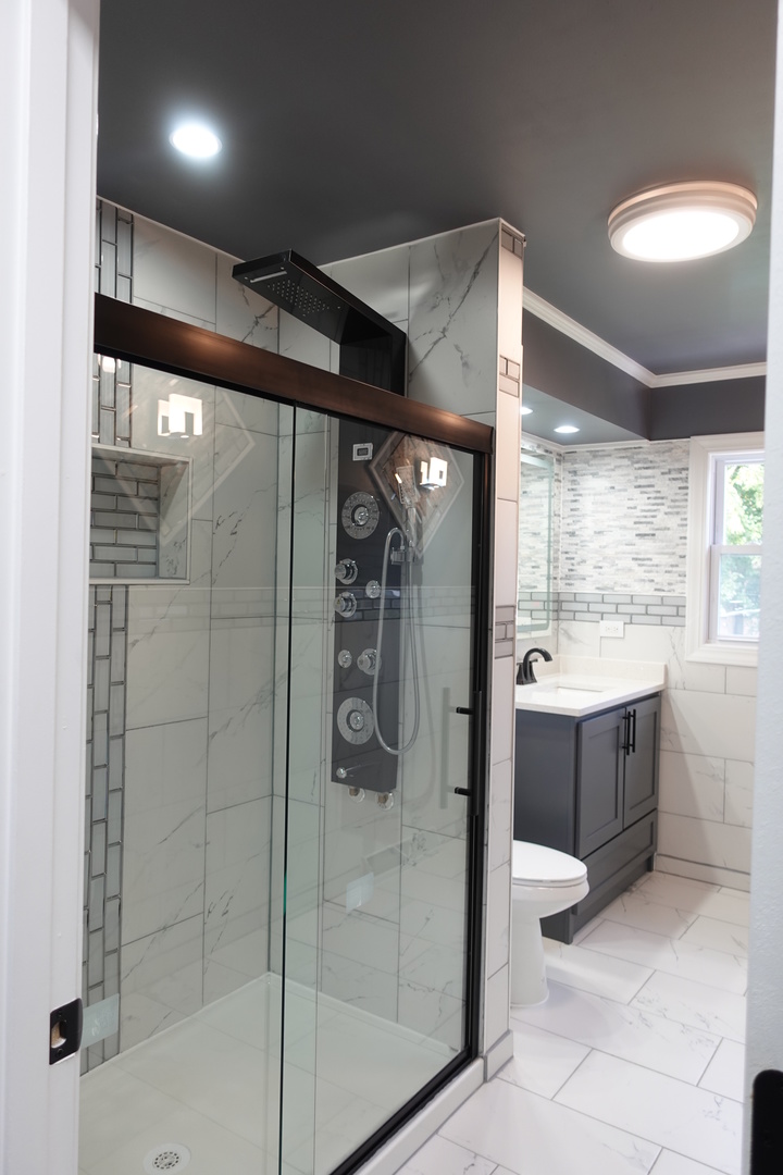 585 Ranger Drive Chicago Heights, IL 60411 - Photo 19 of 48 a bathroom with a glass shower door and a sink