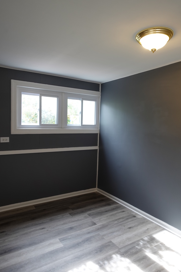 585 Ranger Drive Chicago Heights, IL 60411 - Photo 40 of 48 an empty room with wooden floor and windows