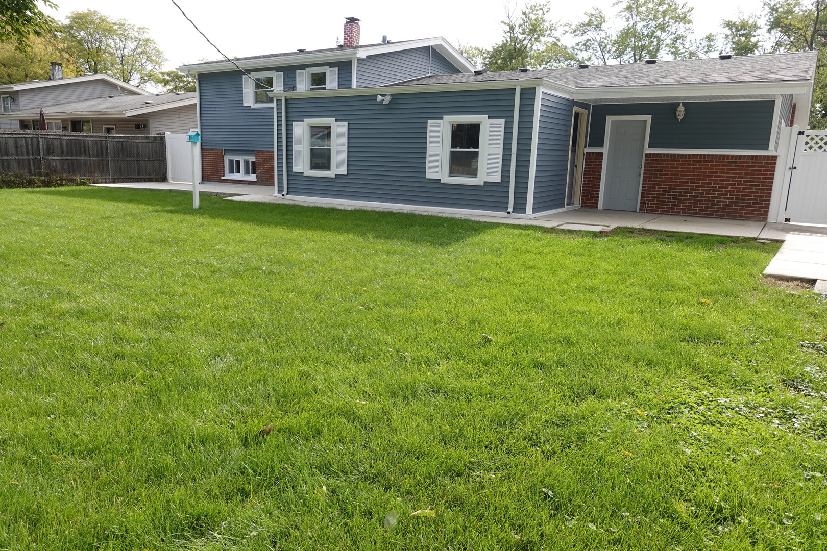 585 Ranger Drive Chicago Heights, IL 60411 - Photo 43 of 48 a front view of a house with a garden and yard
