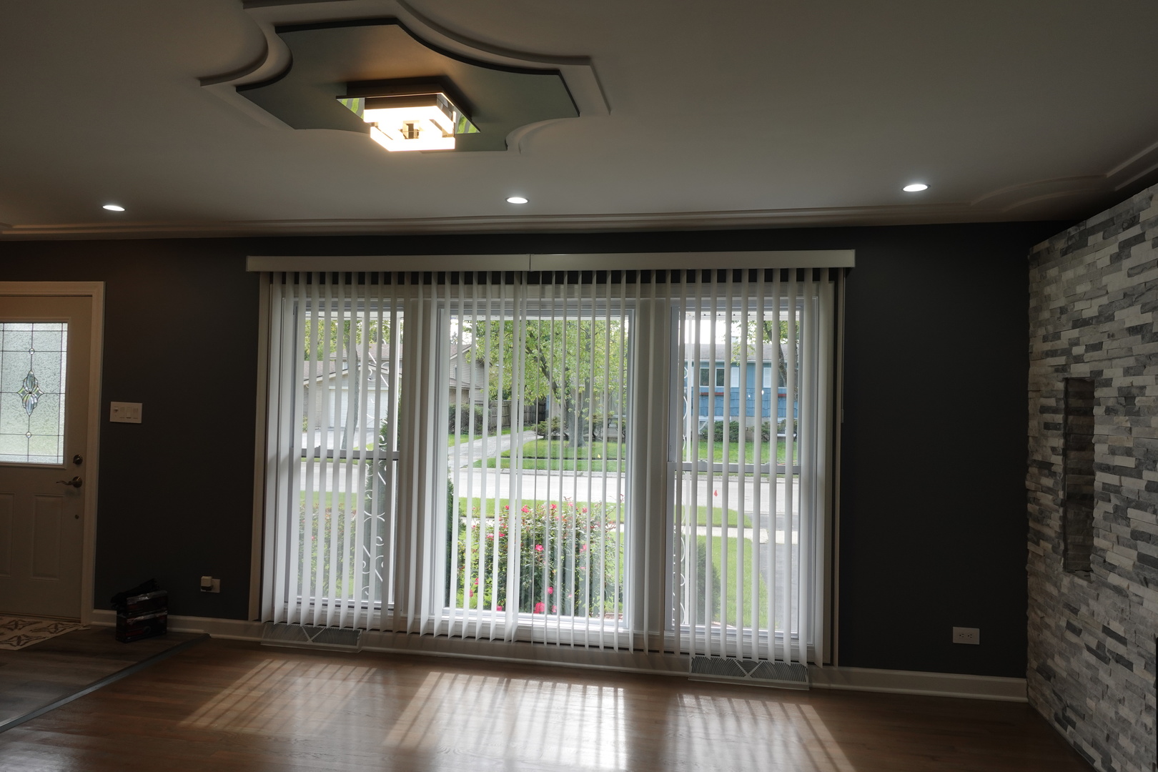 585 Ranger Drive Chicago Heights, IL 60411 - Photo 5 of 48 a view of an empty room with wooden floor and windows
