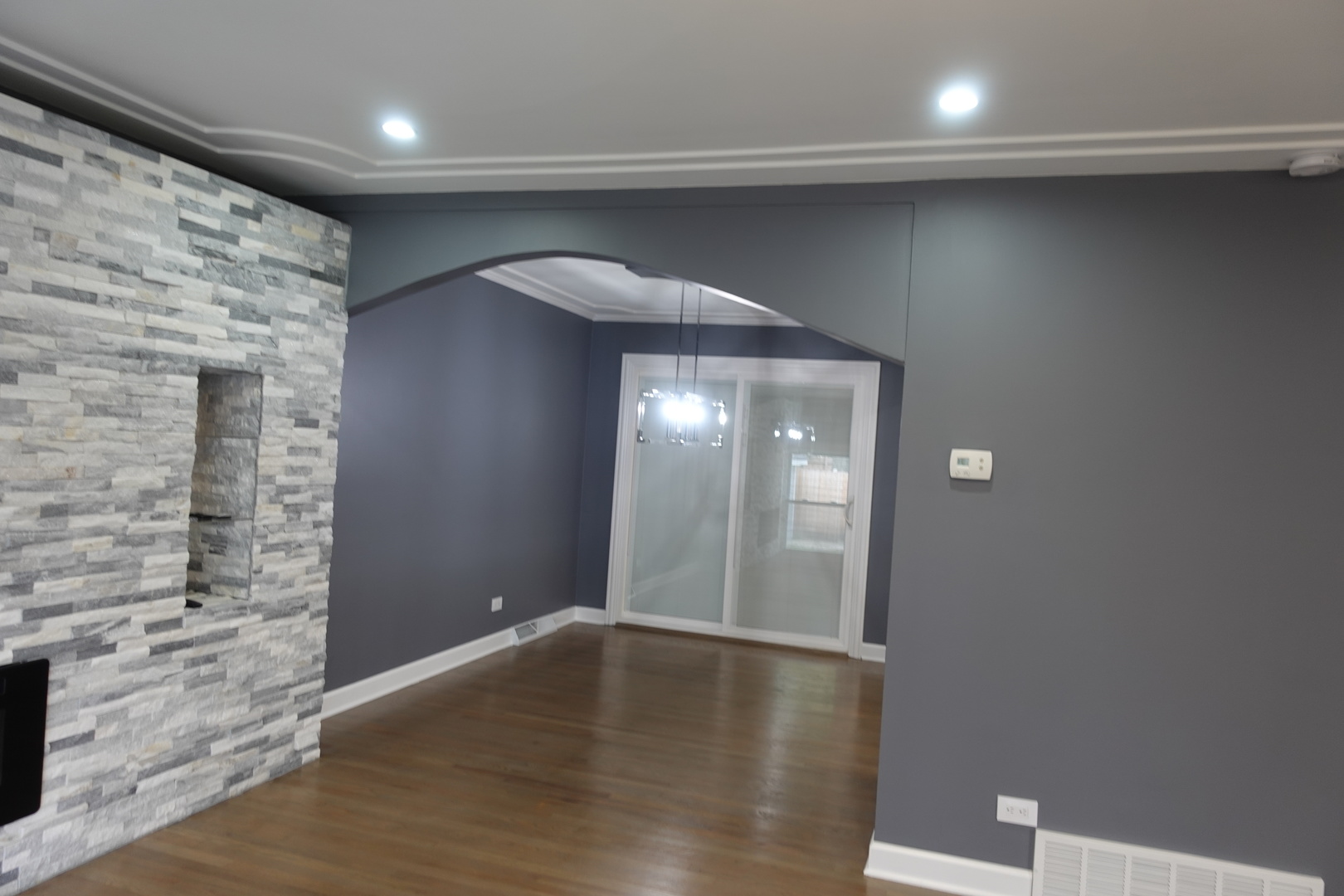 585 Ranger Drive Chicago Heights, IL 60411 - Photo 9 of 48 an empty room with wooden floor and mirror