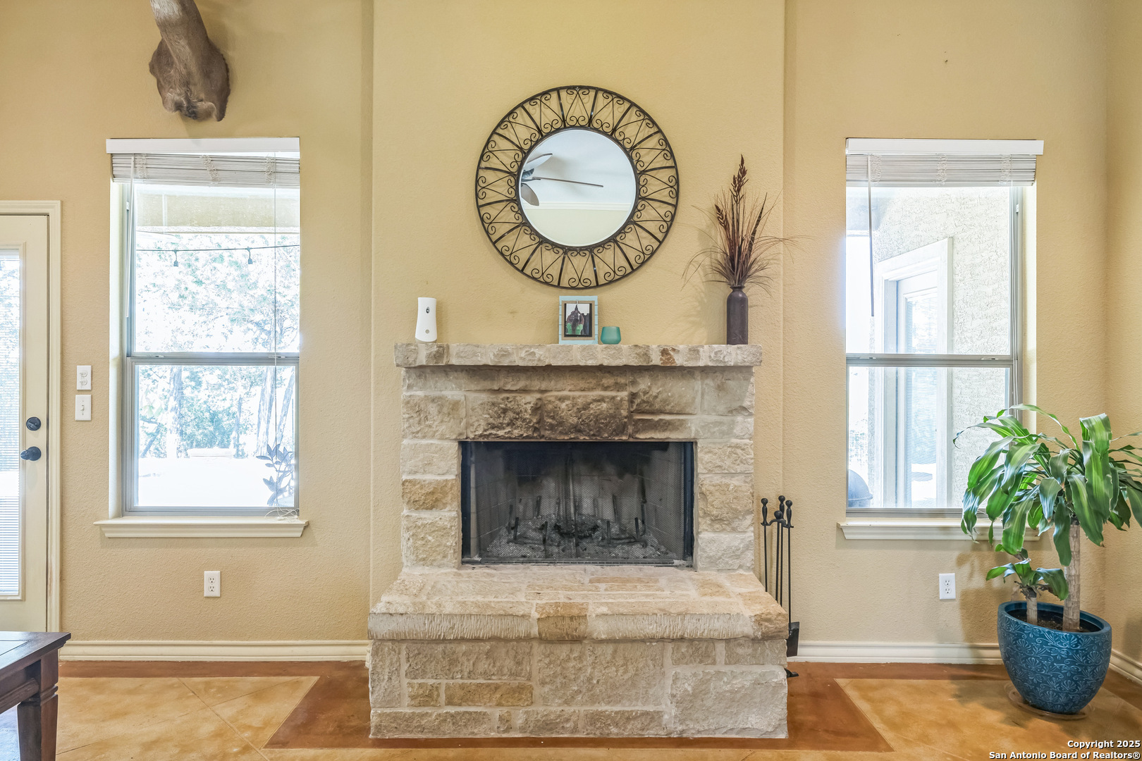 448 Western Bandera, TX 78003 - Photo 12 of 35 a living room with a fireplace and a potted plant