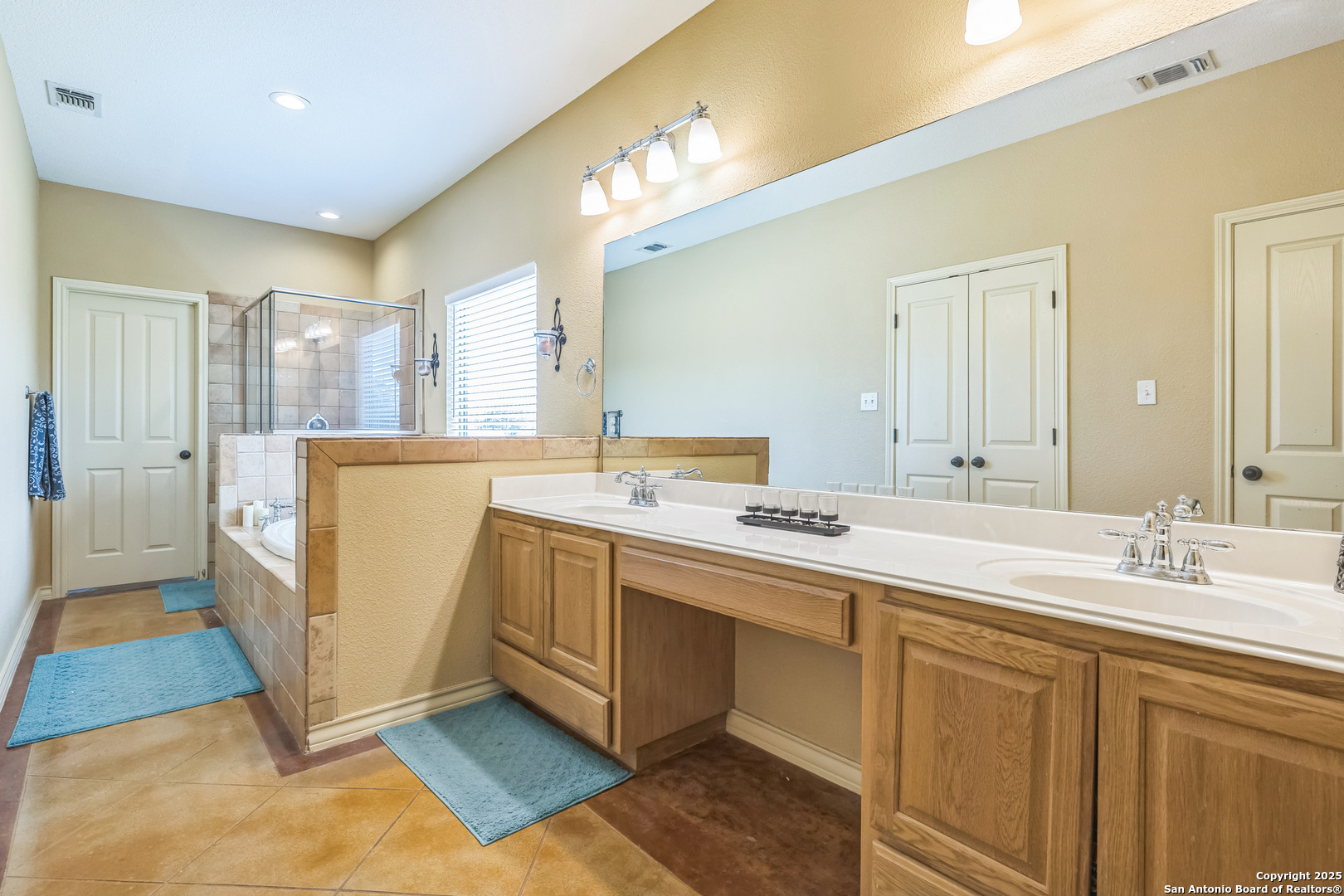 448 Western Bandera, TX 78003 - Photo 13 of 35 a spacious bathroom with a double vanity sink a mirror and a bathtub