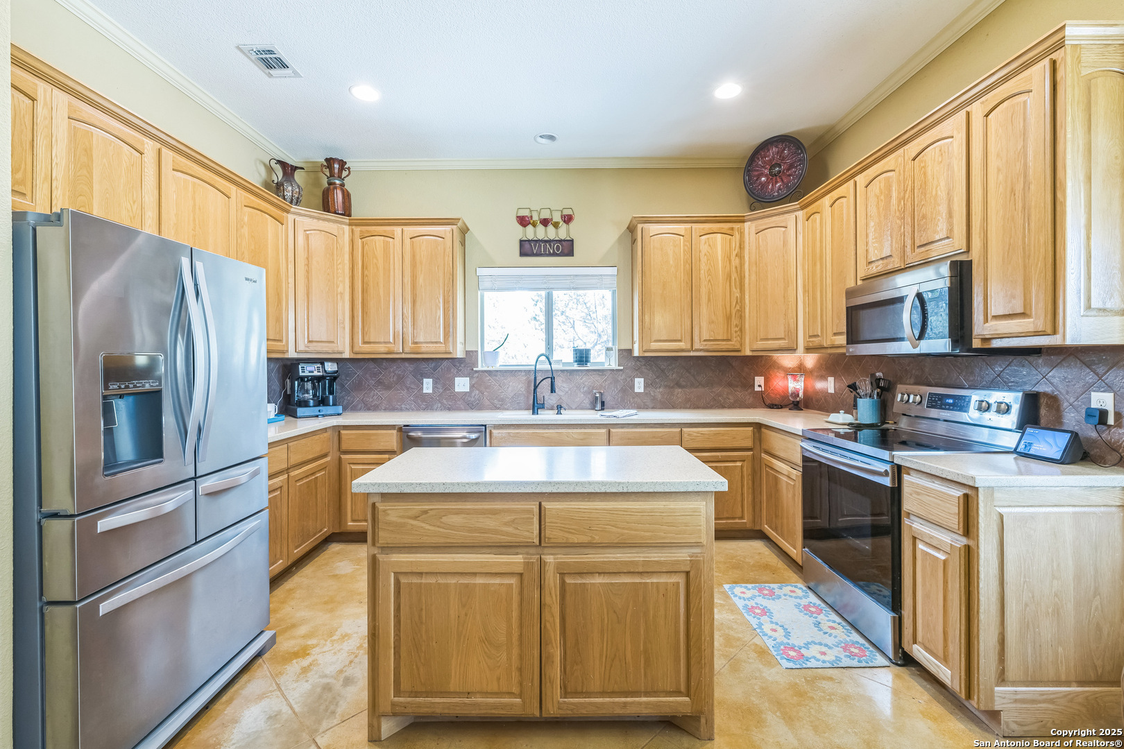 448 Western Bandera, TX 78003 - Photo 15 of 35 a kitchen with stainless steel appliances granite countertop a sink stove and refrigerator