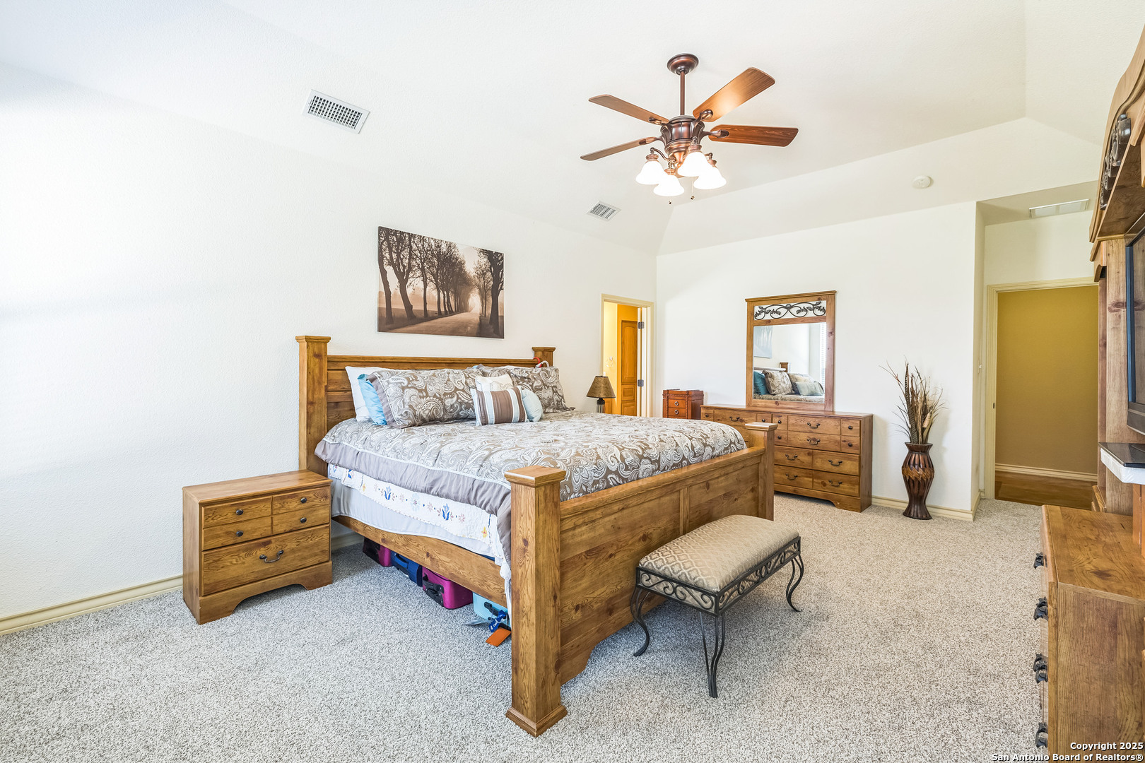448 Western Bandera, TX 78003 - Photo 20 of 35 a bedroom with a bed and a chandelier