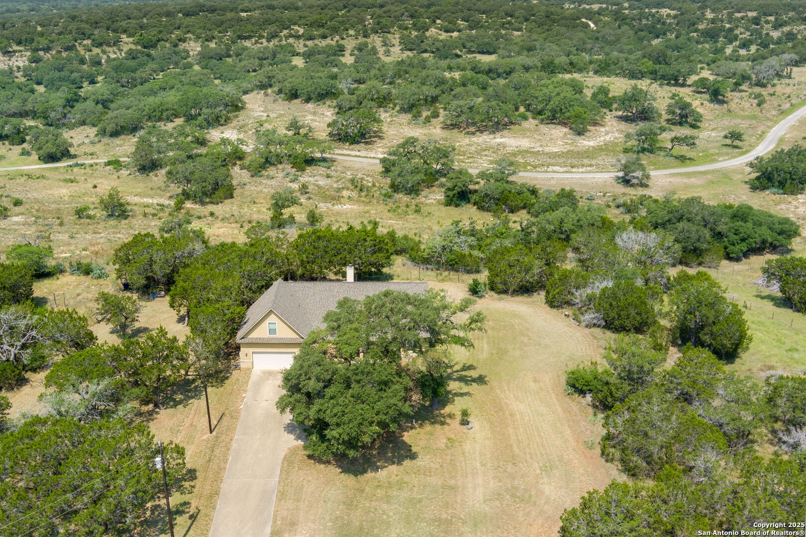 448 Western Bandera, TX 78003 - Photo 2 of 35 an aerial view of residential house with space and trees all around