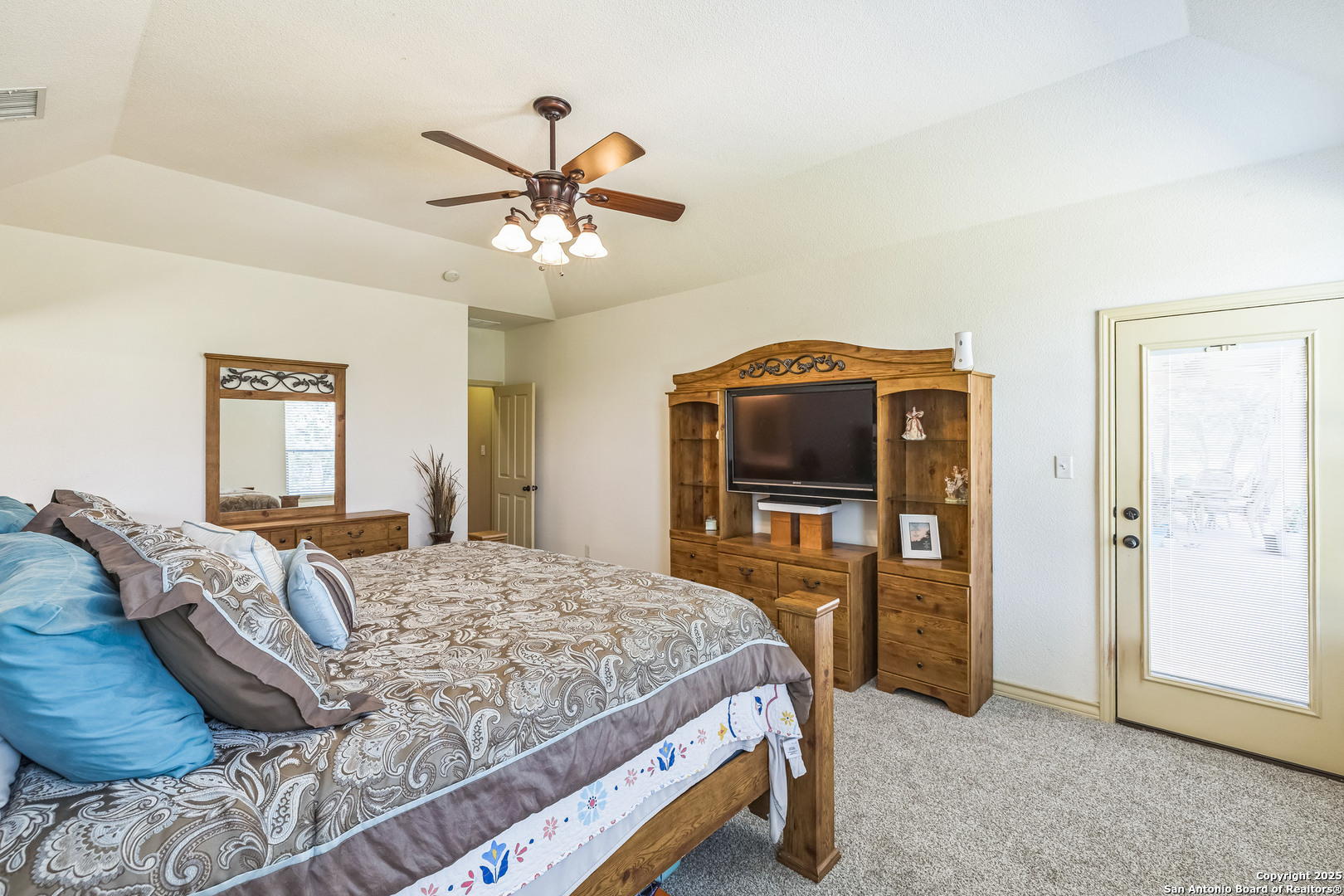 448 Western Bandera, TX 78003 - Photo 22 of 35 a bedroom with a bed and a chandelier