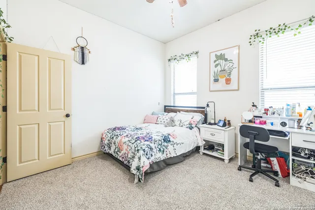 a bedroom that has a bed and a window