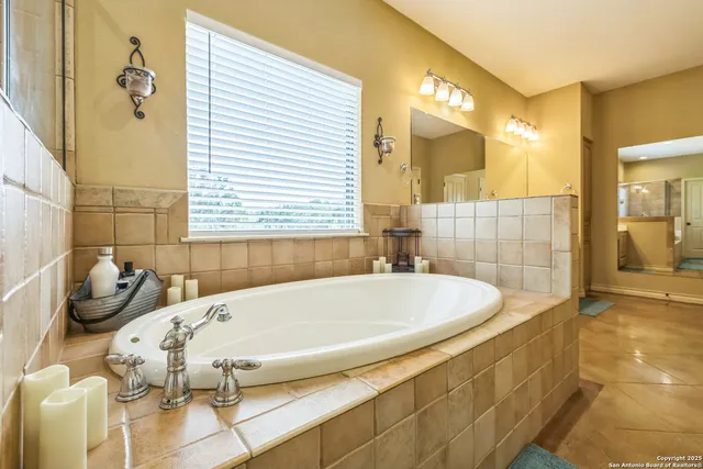 a white bath tub sitting in a bathroom next to a window