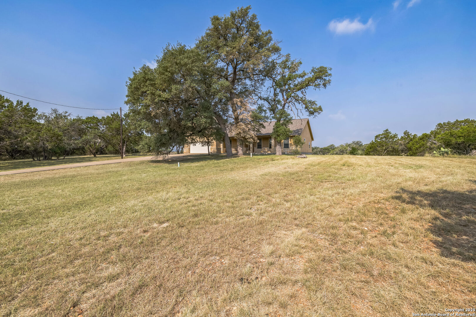 448 Western Bandera, TX 78003 - Photo 4 of 35 a view of yard with ocean and trees in the background